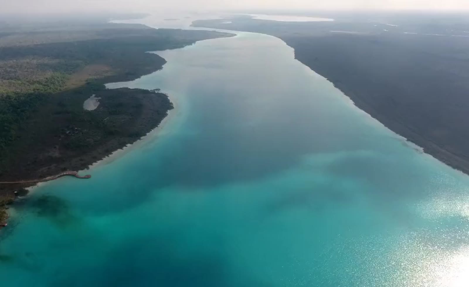 Aerial view of the Bacalar lagoon, a boat on turquoise water