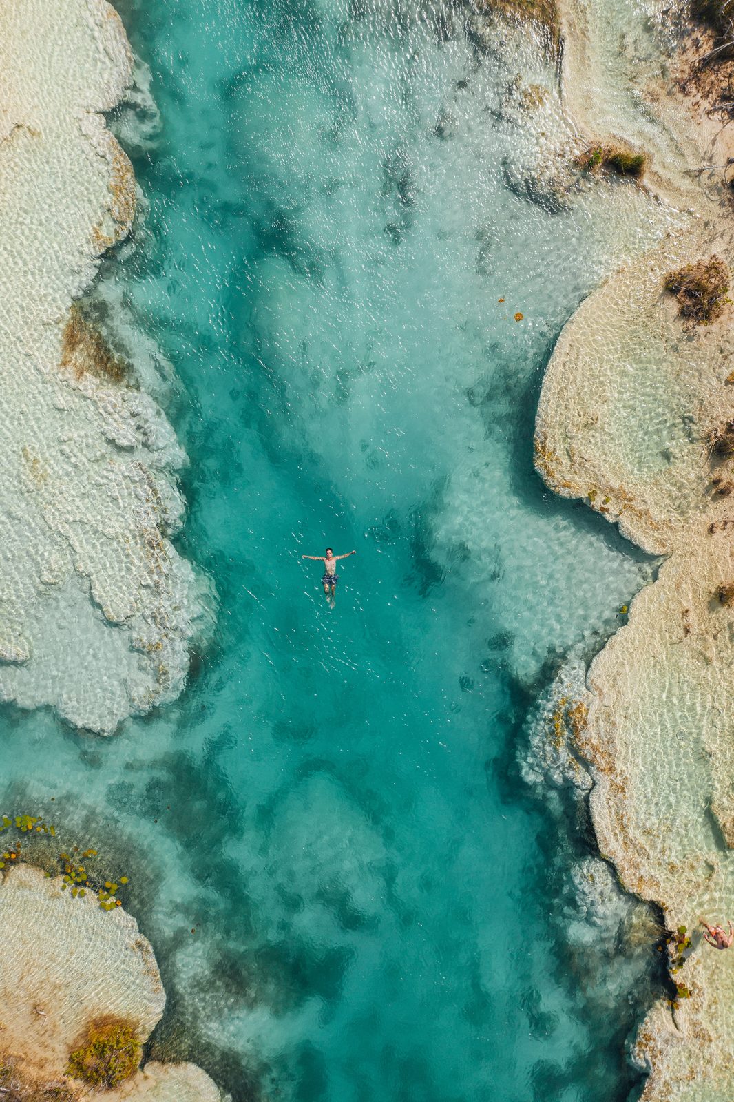 Floating in the clear turquoise lagoon among the limestone shallows