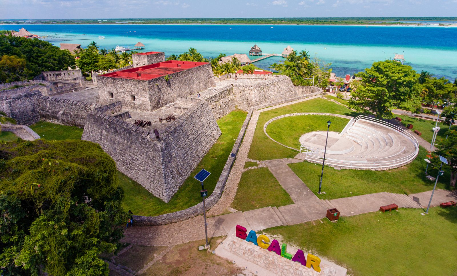 The San Felipe fort and lakeside amphitheatre above the turquoise lagoon, with the colorful Bacalar letters below